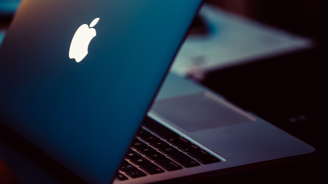 MacBook sitting on desk.