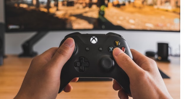 Person playing an Xbox game.