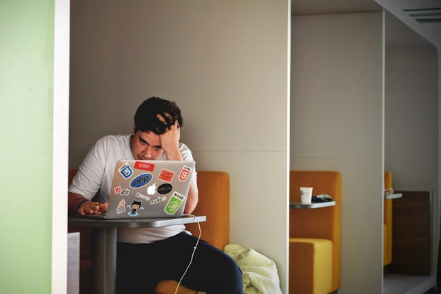Person Stressed In Front Of A Laptop