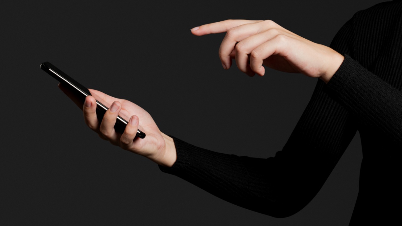 Finger Pressing On A Smartphone Screen