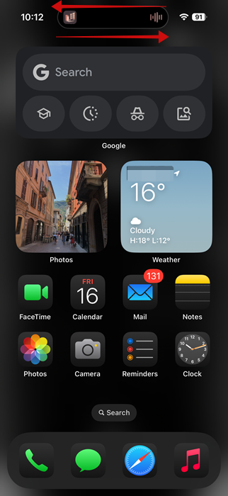 Swiping on the Dynamic Island to hide it or show it again on iPhone screen. 