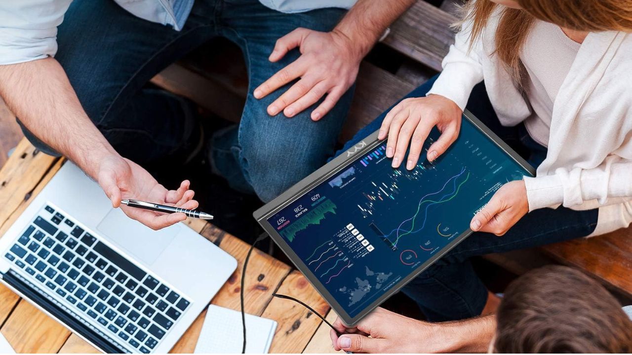 Team Using Portable Monitor to View Information