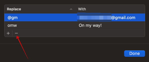 Clicking on - button to remove text shortcut on Mac computer.