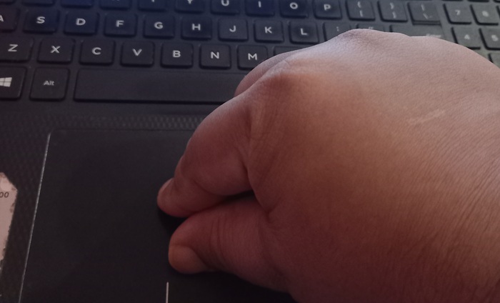 Using index finger and thumb to pinch for "zoom effect" on a touchpad.