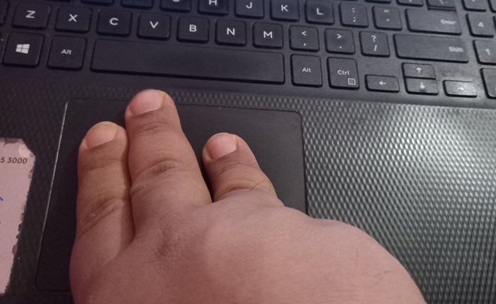 Using three fingers to slide upwards and downwards alternatively.