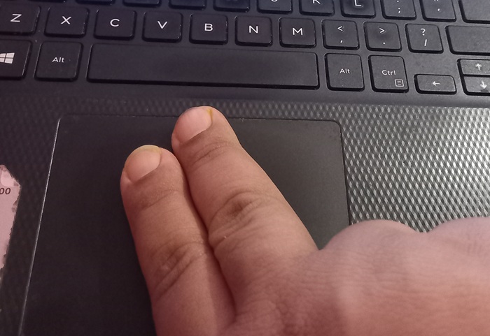 Using two fingers on a trackpad to scroll quickly vertically.