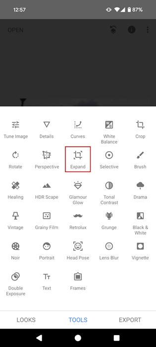 Tapping on the "Expand" feature in Snapseed app.