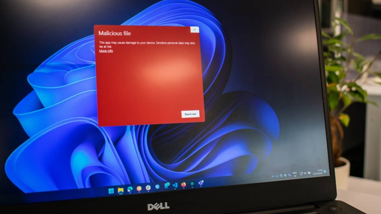 Windows laptop with malicious file warning.