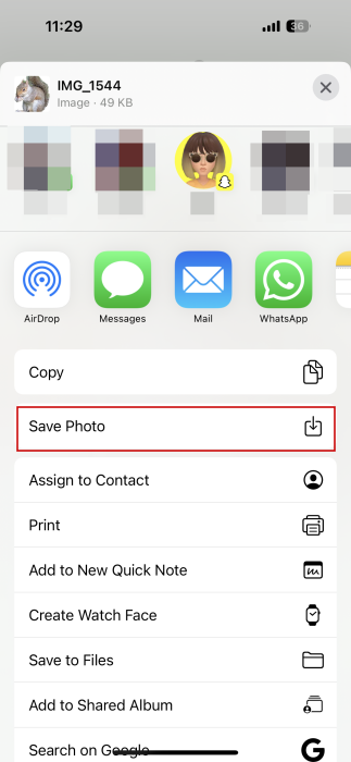 Selecting "Save Photo" for sticker in Messages app on iOS.
