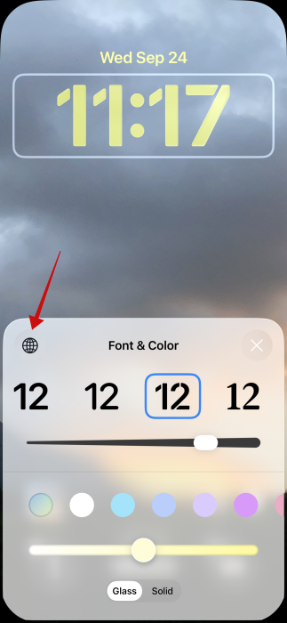 Pressing globe icon in iPhone lock screen.