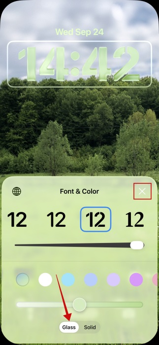 Selecting new glass clock look in iPhone lock screen.