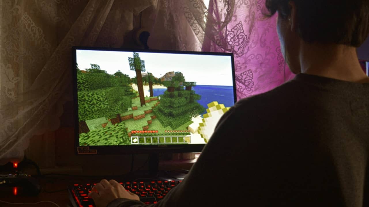 Person playing a game on PC.