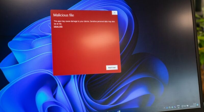 Malicious file warning box on a Windows laptop.