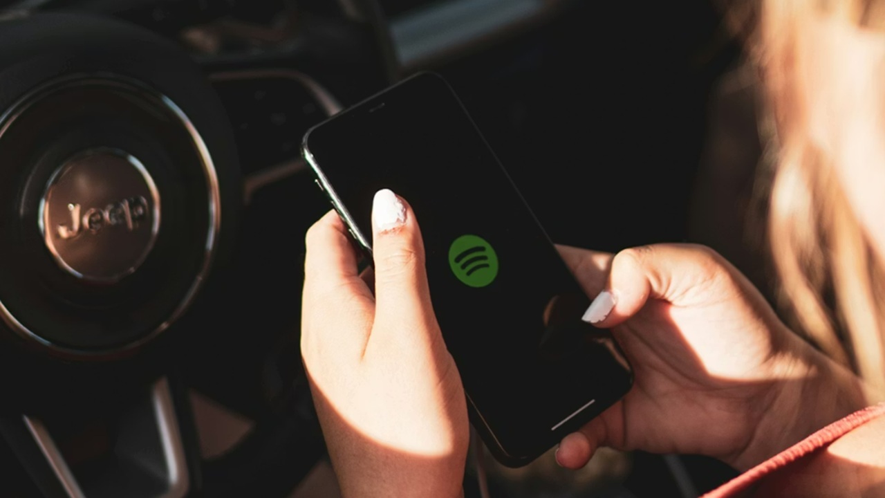 Woman opening Spotify on her phone.