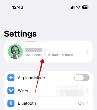Tapping name at top of Settings on iPhone.