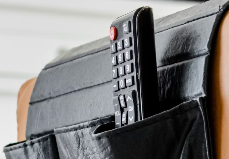 TV remote on couch arm.