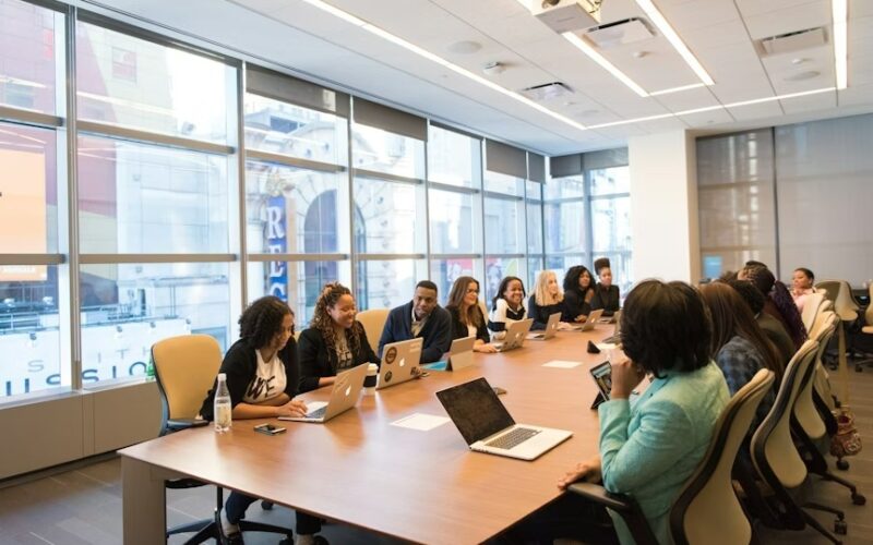 Conference table with numerous people during a business meeting.