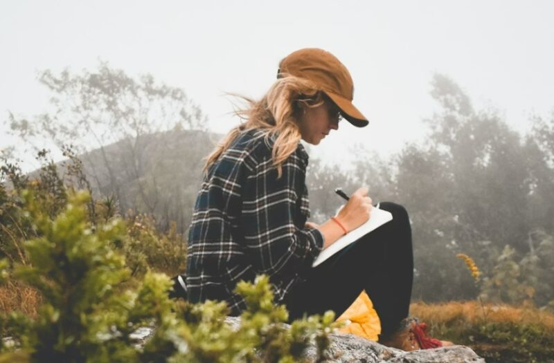 Woman journaling during a daily detox.