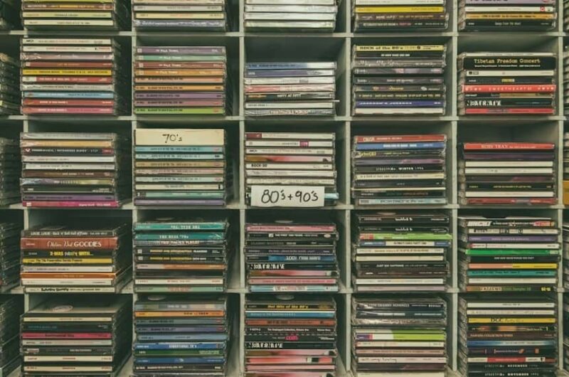 Shelf with numerous CDs from different decades.