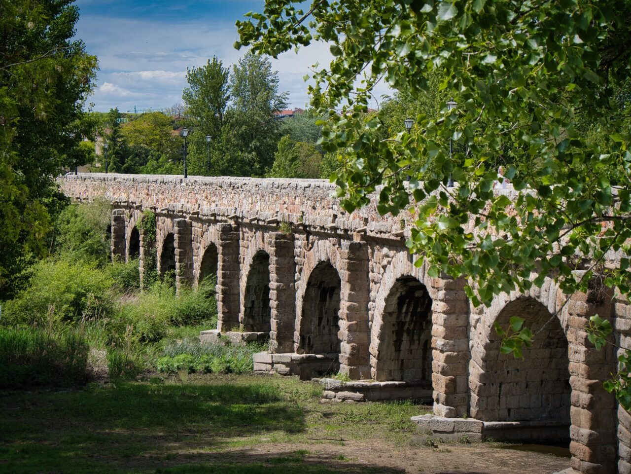 The Roman aqueduct at Segovia, built around the first century AD without mortar, still carried water into the 1970s, its 167 granite arches held together by nothing but the precise weight distribution of stones cut to fit each other within fractions of a millimeter.